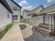 Well-manicured backyard with walkway, landscaping, and stylish raised garden bed at 817 Digby Rd, Rock Hill, SC 29730