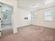 Empty bedroom featuring neutral carpet, multiple windows and TV mount at 817 Digby Rd, Rock Hill, SC 29730