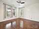 Bright, empty bedroom with hardwood floors and three large windows at 817 Digby Rd, Rock Hill, SC 29730
