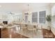 Bright open-concept dining room featuring wood floors, natural light, and a stylish chandelier at 817 Digby Rd, Rock Hill, SC 29730