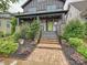 Inviting front porch with stone accents, a bright green front door, and well-manicured landscaping at 817 Digby Rd, Rock Hill, SC 29730