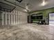Spacious garage with gray walls, overhead storage racks, and built-in cabinets and work bench at 817 Digby Rd, Rock Hill, SC 29730