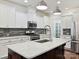 Close-up of kitchen with white cabinets, stainless appliances, and island with seating at 817 Digby Rd, Rock Hill, SC 29730