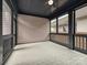 Screened-in porch with wood-look flooring, black beams, and natural lighting at 817 Digby Rd, Rock Hill, SC 29730