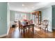 Traditional dining room with hardwood floors, wainscoting, and china cabinet at 8317 Poplar Grove Cir, Waxhaw, NC 28173