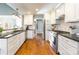 Modern kitchen featuring stainless steel appliances, granite countertops, and white cabinetry at 8317 Poplar Grove Cir, Waxhaw, NC 28173