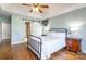 Bright main bedroom with ceiling fan, hardwood floors, barn door, and ensuite access at 8317 Poplar Grove Cir, Waxhaw, NC 28173