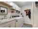 Bright laundry room with washer, dryer, and upper cabinets at 8321 Old Nc 10 Hwy, Hickory, NC 28602