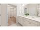Bathroom featuring double sinks, white cabinetry, and view of walk-in closet at 8500 Union Central Ct, Waxhaw, NC 28173