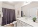 Well-lit bathroom featuring a white vanity, neutral walls, and a shower with a patterned curtain at 8500 Union Central Ct, Waxhaw, NC 28173