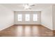 This airy bedroom features hardwood floors and three windows letting in plenty of light at 8500 Union Central Ct, Waxhaw, NC 28173