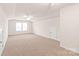 Spacious bonus room featuring neutral carpet, a ceiling fan, and ample natural light at 8500 Union Central Ct, Waxhaw, NC 28173