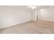 Large bonus room with neutral carpeting, bright walls, and dual ceiling fans at 8500 Union Central Ct, Waxhaw, NC 28173