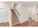 Bright entryway with a carpeted staircase, hardwood floors, and access to other rooms at 8500 Union Central Ct, Waxhaw, NC 28173