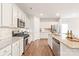 Bright kitchen features stainless steel appliances, granite countertops, and white cabinetry at 8500 Union Central Ct, Waxhaw, NC 28173