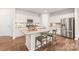 Kitchen with stainless steel appliances, granite countertops, and a stylish island at 8500 Union Central Ct, Waxhaw, NC 28173