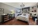 This well-lit main bedroom includes a chandelier and a large window at 9005 St Croix Ln, Charlotte, NC 28277