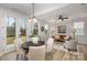 Inviting dining area with a round table and chairs, next to a living room and glass doors to backyard at 903 Cathey Rd, Charlotte, NC 28214