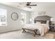 Bright main bedroom featuring a ceiling fan, neutral walls, and a decorative headboard at 903 Cathey Rd, Charlotte, NC 28214