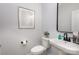 Clean powder room features a pedestal sink, toilet, and modern fixtures at 903 Cathey Rd, Charlotte, NC 28214