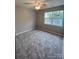 Bright bedroom with ceiling fan, carpet, and large window at 9103 Exbury Ct, Charlotte, NC 28269