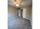 Spacious bedroom with ceiling fan, carpet, and double-door closet at 9103 Exbury Ct, Charlotte, NC 28269