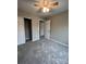 Bedroom with ceiling fan, carpet, and access to a hallway bathroom at 9103 Exbury Ct, Charlotte, NC 28269