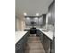 Modern kitchen featuring gray cabinets, quartz countertops, and stainless steel appliances at 9103 Exbury Ct, Charlotte, NC 28269