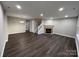 Living room featuring hardwood floors, fireplace, and neutral color palette at 9103 Exbury Ct, Charlotte, NC 28269