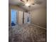 Large main bedroom with ceiling fan, carpet, and private bathroom access at 9103 Exbury Ct, Charlotte, NC 28269