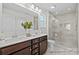 Bathroom featuring double sinks, a tiled shower with glass doors, and neutral decor at 110 Shay Crossing Rd # 1P, Salisbury, NC 28144