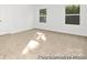 Well-lit bedroom featuring neutral carpet and two windows at 110 Shay Crossing Rd # 1P, Salisbury, NC 28144
