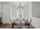Dining area featuring a chandelier and modern decor, adjacent to a doorway at 110 Shay Crossing Rd # 1P, Salisbury, NC 28144