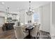 Dining area featuring a chandelier and modern decor, adjacent to the kitchen at 110 Shay Crossing Rd # 1P, Salisbury, NC 28144