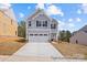 Two-story home with neutral siding, two-car garage, and long driveway at 110 Shay Crossing Rd # 1P, Salisbury, NC 28144
