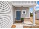 Charming entryway with blue front door, welcome mat, brick accents, and vertical siding details at 110 Shay Crossing Rd # 1P, Salisbury, NC 28144