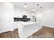 Modern kitchen features white cabinets, stainless steel appliances, and a large center island with pendant lighting at 110 Shay Crossing Rd # 1P, Salisbury, NC 28144