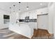 Modern kitchen features white cabinets, stainless steel appliances, and a large center island with pendant lighting at 110 Shay Crossing Rd # 1P, Salisbury, NC 28144