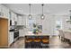 Bright, open kitchen with island, bar stool seating, stainless appliances, granite countertops, and modern lighting at 110 Shay Crossing Rd # 1P, Salisbury, NC 28144