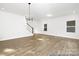 Open living area with hardwood floors, staircase, and abundant natural light at 110 Shay Crossing Rd # 1P, Salisbury, NC 28144