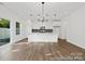 Open-concept living space features hardwood floors, pendant lighting and access to the kitchen at 110 Shay Crossing Rd # 1P, Salisbury, NC 28144