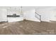 Spacious living area featuring hardwood floors, white walls, and a staircase to the second floor at 110 Shay Crossing Rd # 1P, Salisbury, NC 28144