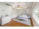 Bright bedroom with a trey ceiling, ceiling fan, hardwood floors, and coordinated furnishings at 1101 S Wendover Rd, Charlotte, NC 28211