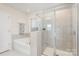 Relaxing bathroom features a soaking tub, glass-enclosed shower, and neutral tile at 1111 Fairbrae Ln, Indian Trail, NC 28079