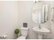 Cozy powder room features a pedestal sink, decorative mirror, and charming decor at 1111 Fairbrae Ln, Indian Trail, NC 28079