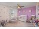 Charming bedroom features a crib, rocking chair, and whimsical wall decor at 1111 Fairbrae Ln, Indian Trail, NC 28079