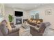 Inviting living room with a fireplace, comfortable seating, and plenty of natural light at 1111 Fairbrae Ln, Indian Trail, NC 28079