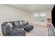 Comfortable living room offering plush seating, natural light, and a recreational space at 1111 Fairbrae Ln, Indian Trail, NC 28079