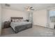 Serene bedroom boasts a plush bed, neutral tones, and natural light from the window at 1111 Fairbrae Ln, Indian Trail, NC 28079