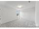 Bedroom featuring neutral walls, carpeted floors and a large window at 112 Stonewater Dr # 33P, Red Cross, NC 28129